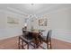 Elegant dining area with a stylish table, chandelier, and wainscoting at 316 Hilliard Forest Dr, Cary, NC 27519
