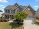 Charming brick two-story home with landscaped front yard and attached two-car garage at 316 Hilliard Forest Dr, Cary, NC 27519