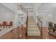 Spacious foyer with staircase, hardwood floors, and views into multiple living areas at 316 Hilliard Forest Dr, Cary, NC 27519