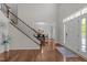 Elegant foyer with hardwood floors, staircase, and a view of the dining area at 316 Hilliard Forest Dr, Cary, NC 27519