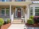 Inviting front entrance with a decorative wreath, brick steps, and manicured landscaping at 316 Hilliard Forest Dr, Cary, NC 27519