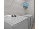 Convenient laundry room with modern appliances and storage shelves for laundry supplies at 316 Hilliard Forest Dr, Cary, NC 27519