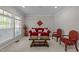 Cozy living room with neutral carpet, a bright window, and classic furnishings at 316 Hilliard Forest Dr, Cary, NC 27519