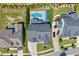Aerial view showcasing a private backyard oasis with a sparkling pool, patio area, and lush greenery at 3205 Silver Ore Ct, Wake Forest, NC 27587
