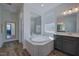 A bright bathroom with a soaking tub and shower at 3205 Silver Ore Ct, Wake Forest, NC 27587