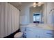 Comfortable bathroom features a shower with curtain, vanity, toilet, and white accents at 3205 Silver Ore Ct, Wake Forest, NC 27587