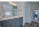 A clean bathroom that features gray cabinets and double mirrors at 3205 Silver Ore Ct, Wake Forest, NC 27587