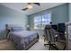 Bedroom features a bed, desk, window, and light blue walls with a ceiling fan at 3205 Silver Ore Ct, Wake Forest, NC 27587