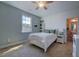 Bright bedroom features a ceiling fan, fresh paint, large window, and connecting bathroom at 3205 Silver Ore Ct, Wake Forest, NC 27587