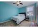 Cozy bedroom features a bed, window, and side table with calming teal walls at 3205 Silver Ore Ct, Wake Forest, NC 27587