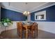 Elegant dining room with hardwood floors, wainscoting, and stylish chandelier at 3205 Silver Ore Ct, Wake Forest, NC 27587