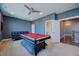 Finished game room includes a pool table, plush couch, and doorway to a bathroom at 3205 Silver Ore Ct, Wake Forest, NC 27587