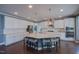 Modern kitchen with large island, granite countertops, stainless steel appliances, and ample cabinet space at 3205 Silver Ore Ct, Wake Forest, NC 27587