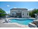 Gorgeous backyard pool with waterfall feature, lounge area, and well-maintained landscaping at 3205 Silver Ore Ct, Wake Forest, NC 27587