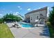 Backyard pool includes a slide, stone accents, umbrella-covered chairs, and home exterior at 3205 Silver Ore Ct, Wake Forest, NC 27587