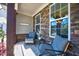 Inviting covered porch with stone accents, comfortable seating, and relaxing ambiance at 3205 Silver Ore Ct, Wake Forest, NC 27587