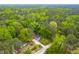 Aerial view shows the home nestled within lush, mature landscaping, offering a sense of seclusion and privacy at 329 Cartwright Cir, Wendell, NC 27591