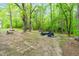 Secluded backyard setting with mature trees, a fire pit, and outdoor seating, ideal for entertaining at 329 Cartwright Cir, Wendell, NC 27591