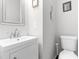 Compact half-bathroom with a sleek white vanity, modern fixtures, and neutral walls at 329 Cartwright Cir, Wendell, NC 27591