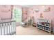 Charming Bedroom features a crib, rocking chair, and changing table in a cozy, pink-themed space at 329 Cartwright Cir, Wendell, NC 27591