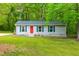 Charming single-story home featuring a bright red front door and well-maintained green lawn at 329 Cartwright Cir, Wendell, NC 27591