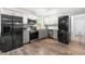 Bright kitchen with stainless steel appliances, light countertops, and an adjacent laundry area at 329 Cartwright Cir, Wendell, NC 27591