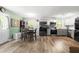 Open kitchen and dining area with stainless steel appliances and modern gray and white cabinets at 329 Cartwright Cir, Wendell, NC 27591