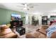 Open-concept living and dining area with a large TV, comfortable seating, and lots of natural light at 329 Cartwright Cir, Wendell, NC 27591