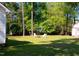 Tree-lined backyard featuring a fire pit and multiple seating areas at 334 Cabin Grove Ct, Angier, NC 27501