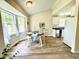 Bright dining area featuring a round table set by large windows, open to the kitchen at 334 Cabin Grove Ct, Angier, NC 27501