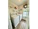 Functional laundry room with modern washer and dryer, overhead shelving and natural light at 334 Cabin Grove Ct, Angier, NC 27501