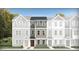 Charming townhouse with gray siding, stone accents, and a welcoming red front door at 336 Carolina Springs Blvd, Apex, NC 27539