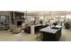 Open-concept living room with modern furnishings, fireplace, and seamless flow to dining at 336 Carolina Springs Blvd, Apex, NC 27539