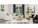 Cozy living area with white sectional, woven ottoman, and natural light from windows at 336 Carolina Springs Blvd, Apex, NC 27539