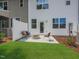 Backyard with privacy fence and patio area with seating and a fire pit at 373 Thompson Overlook Way # 233, Smithfield, NC 27577