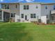 Spacious backyard patio area with modern seating, fire pit, and lawn at 373 Thompson Overlook Way # 233, Smithfield, NC 27577