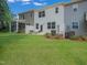 Exterior view showcasing a backyard with a patio seating area and lawn at 373 Thompson Overlook Way # 233, Smithfield, NC 27577