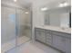 Bright bathroom showcasing glass shower and double sink vanity at 373 Thompson Overlook Way # 233, Smithfield, NC 27577