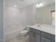 Bathroom features a shower/tub combo, gray vanity, mirror, and neutral walls at 373 Thompson Overlook Way # 233, Smithfield, NC 27577