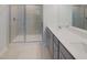 Modern bathroom with glass shower, gray vanity, and double sinks at 373 Thompson Overlook Way # 233, Smithfield, NC 27577