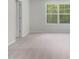 Neutral bedroom with large window offering a green outdoor view at 373 Thompson Overlook Way # 233, Smithfield, NC 27577