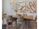 Light and airy dining room featuring wood table, striped chairs, and modern art at 373 Thompson Overlook Way # 233, Smithfield, NC 27577