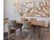 Inviting dining room with modern art, a wooden table and striped chairs at 373 Thompson Overlook Way # 233, Smithfield, NC 27577
