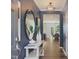 Hallway decorated with a large mirror and modern wallpaper at 373 Thompson Overlook Way # 233, Smithfield, NC 27577