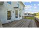 A spacious wood deck features the back entrance and large windows at 3809 Long Meadow Dr, Mebane, NC 27302