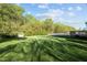 A wide back yard features lush grass and mature trees at 3809 Long Meadow Dr, Mebane, NC 27302