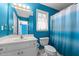 Bright bathroom with white vanity, toilet and blue and white shower curtain at 3809 Long Meadow Dr, Mebane, NC 27302