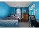 Inviting bedroom with blue walls, carpet flooring, window and adjacent bathroom at 3809 Long Meadow Dr, Mebane, NC 27302