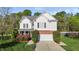 Charming two-story home with white siding, brick accents, well-maintained landscaping, and a two-car garage at 3809 Long Meadow Dr, Mebane, NC 27302