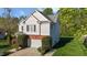 Two-story home with white siding, brick accents, mature landscaping, and a two-car garage at 3809 Long Meadow Dr, Mebane, NC 27302